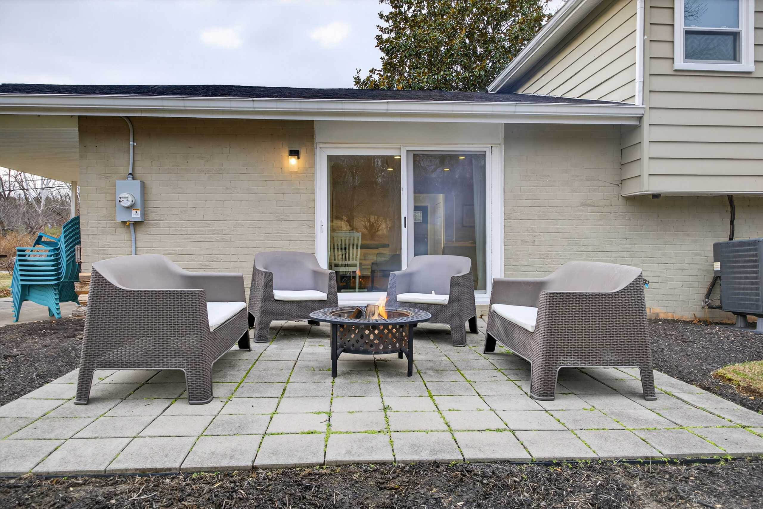 Outdoor patio lounge with armchairs and a fire pit at a premium vacation rental.